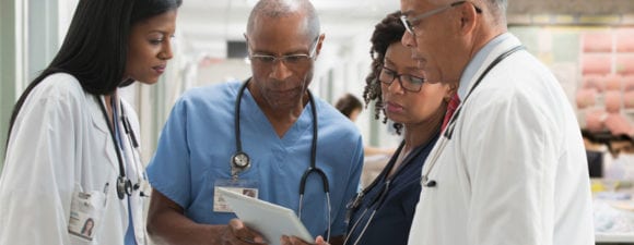 doctors and nurses reviewing a chart