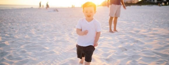 A child on the beach using autism exercise best practices