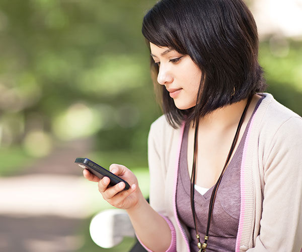 woman looks at phone