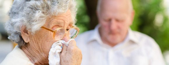 older woman using handkerchief