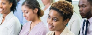 a diverse group of colleagues listen to a seminar