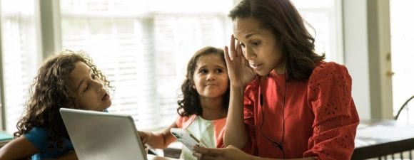 Woman on laptop with kids