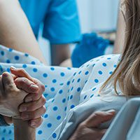 family member supporting a pregnant patient during emergency